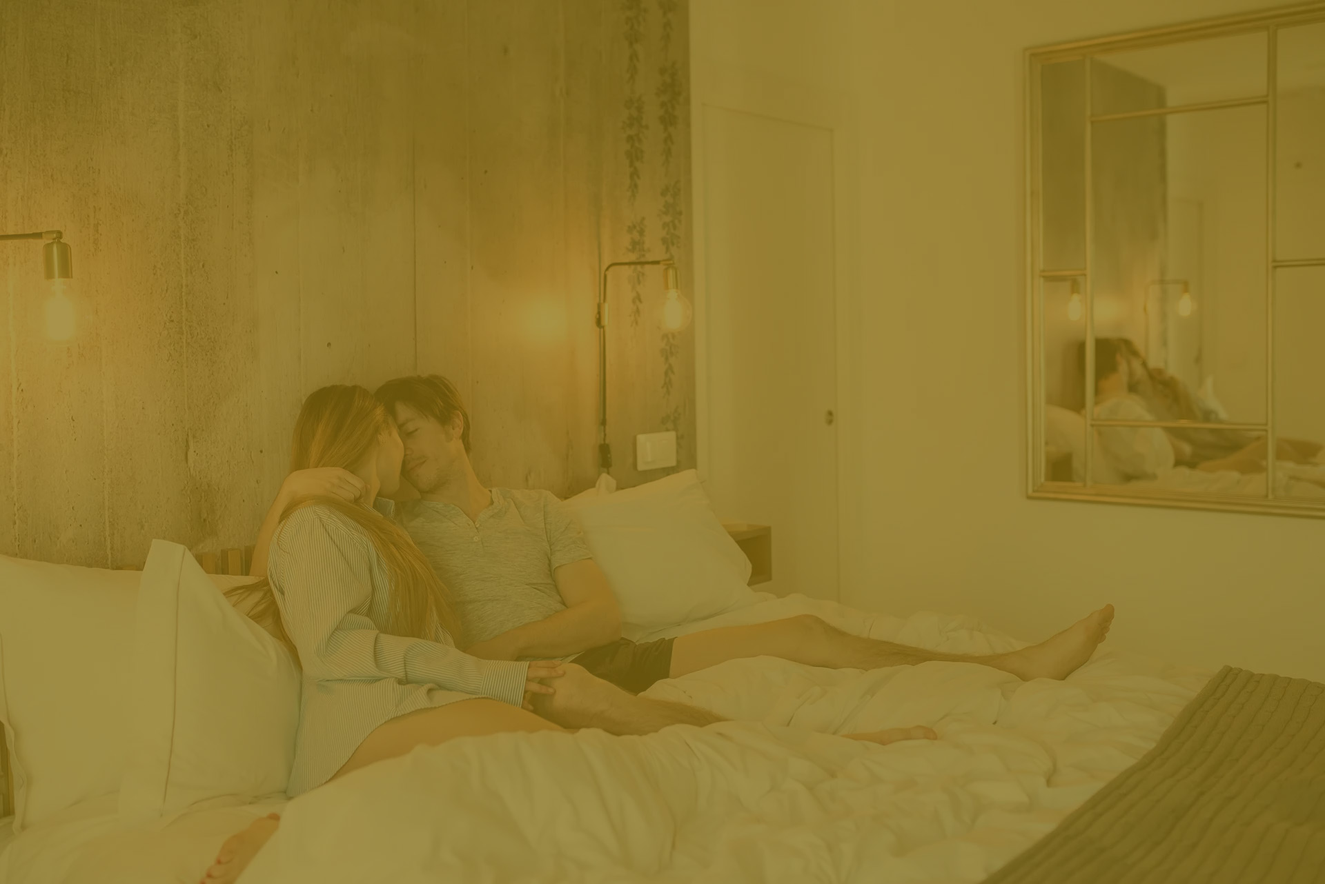 Happy couple lounging in bed