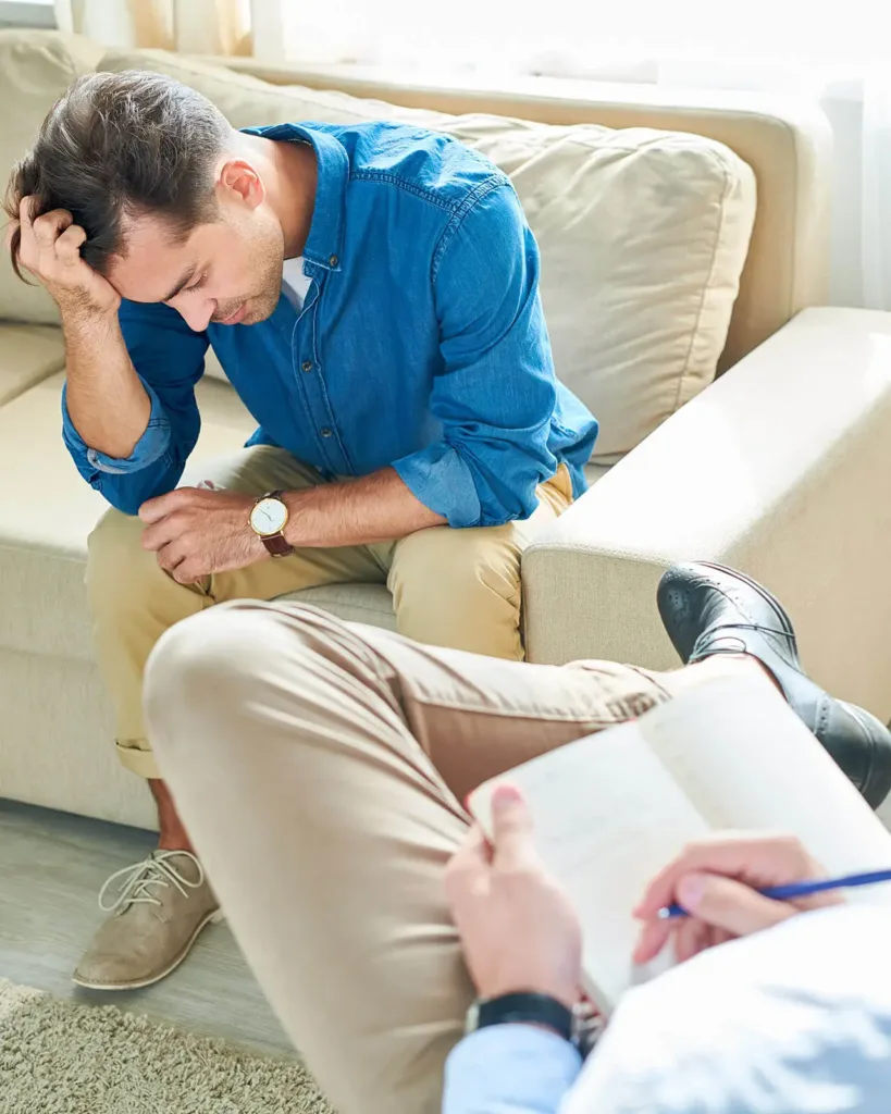 Man in therapy sitting on sofa
